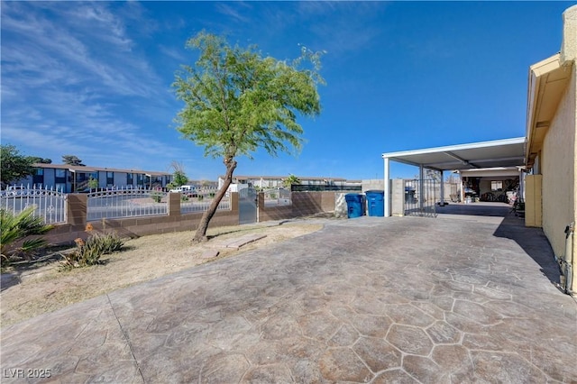 view of yard featuring a residential view, a gate, and fence