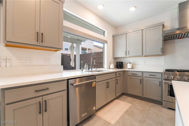 7307 Grace Estate Ave, Las Vegas, NV 89113 - kitchen with a sink, wall chimney range hood, gray cabinets, light countertops, and appliances with stainless steel finishes