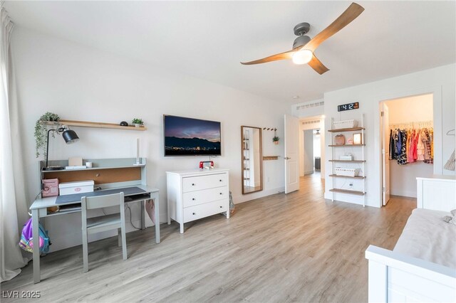 7307 Grace Estate Ave, Las Vegas, NV 89113 - bedroom with a walk in closet, a ceiling fan, and wood finished floors