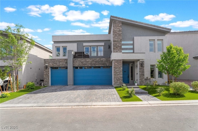 7307 Grace Estate Ave, Las Vegas, NV 89113 - modern home with stone siding, stucco siding, a balcony, and a garage