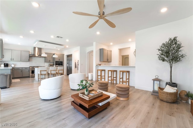 7307 Grace Estate Ave, Las Vegas, NV 89113 - living area with recessed lighting, visible vents, a ceiling fan, arched walkways, and light wood-type flooring