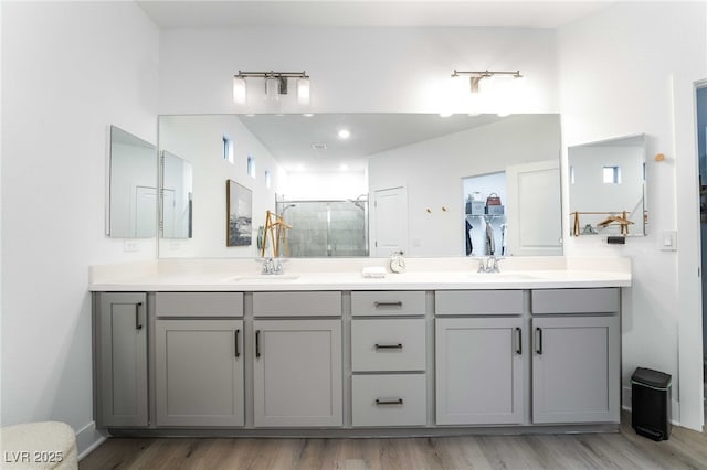 7307 Grace Estate Ave, Las Vegas, NV 89113 - full bath featuring wood finished floors, a sink, double vanity, and a stall shower
