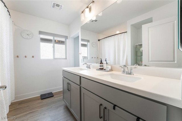 7307 Grace Estate Ave, Las Vegas, NV 89113 - bathroom with baseboards, wood finished floors, visible vents, and a sink