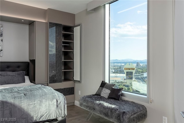 bedroom with baseboards and wood finished floors