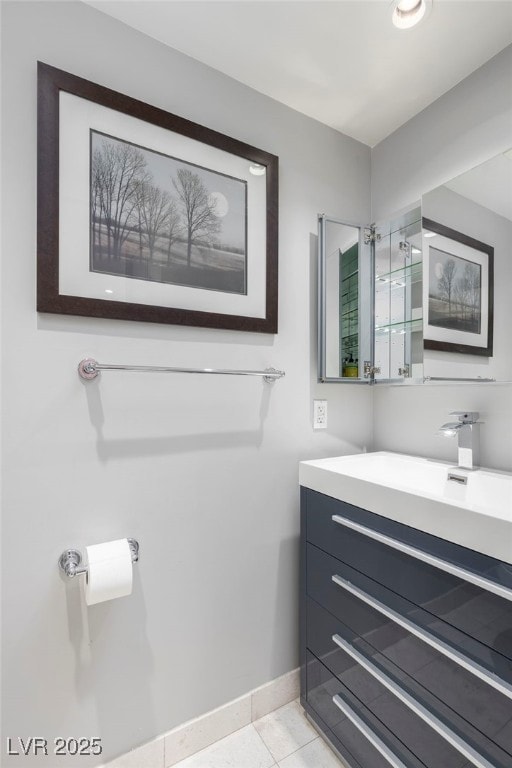 bathroom featuring tile patterned floors, baseboards, and vanity