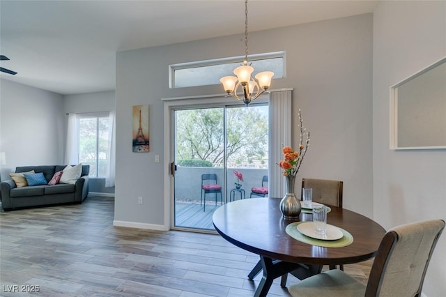 2305 W Horizon Ridge Pkwy Unit 3713, Henderson, NV 89052 - dining room featuring baseboards, an inviting chandelier, wood finished floors, and a wealth of natural light