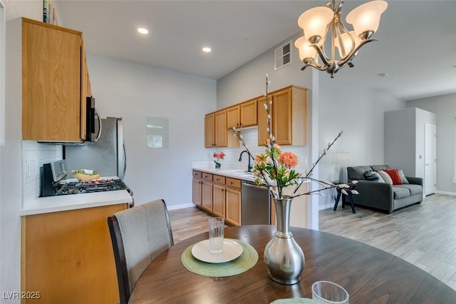 2305 W Horizon Ridge Pkwy Unit 3713, Henderson, NV 89052 - dining area with light wood-type flooring, baseboards, visible vents, and an inviting chandelier