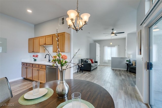 2305 W Horizon Ridge Pkwy Unit 3713, Henderson, NV 89052 - dining space featuring ceiling fan with notable chandelier, baseboards, visible vents, and light wood-style floors