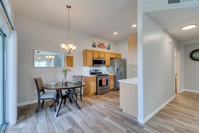 2305 W Horizon Ridge Pkwy Unit 3713, Henderson, NV 89052 - kitchen featuring light countertops, visible vents, light wood-style flooring, appliances with stainless steel finishes, and a notable chandelier