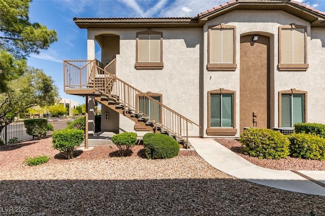 2305 W Horizon Ridge Pkwy Unit 3713, Henderson, NV 89052 - exterior space featuring stairway, a tile roof, fence, and stucco siding
