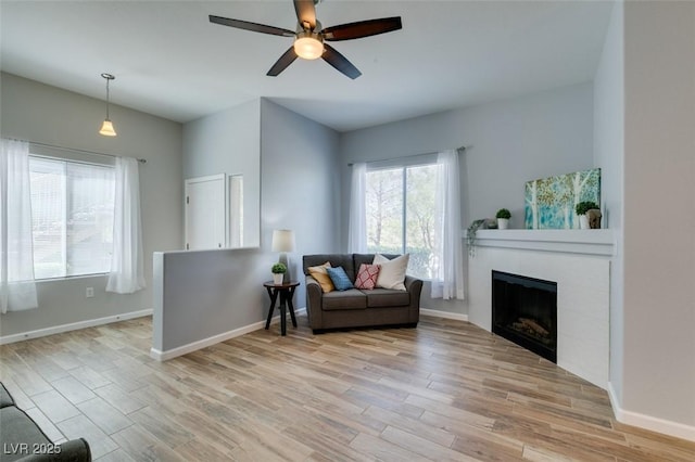 2305 W Horizon Ridge Pkwy Unit 3713, Henderson, NV 89052 - living area with a tiled fireplace, baseboards, a ceiling fan, and light wood-type flooring