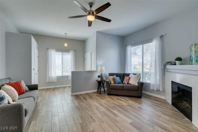 2305 W Horizon Ridge Pkwy Unit 3713, Henderson, NV 89052 - living area with a glass covered fireplace, baseboards, light wood-style floors, and ceiling fan