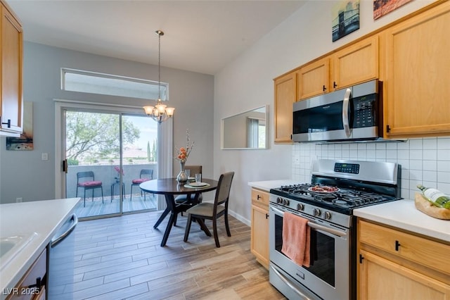 2305 W Horizon Ridge Pkwy Unit 3713, Henderson, NV 89052 - kitchen featuring tasteful backsplash, a chandelier, light wood-style floors, light countertops, and appliances with stainless steel finishes