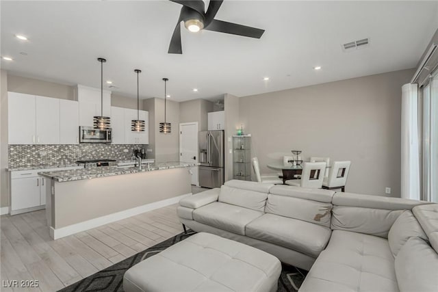 3208 Lumassina Way, Henderson, NV 89044 - living room with light wood-type flooring, ceiling fan, baseboards, visible vents, and recessed lighting