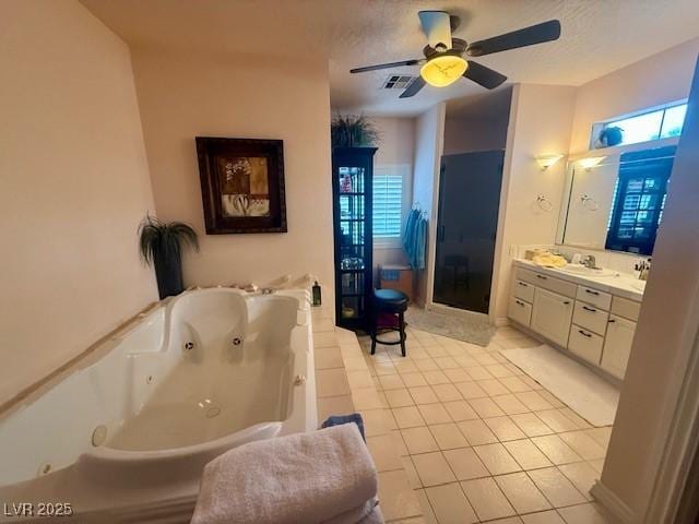10561 Rancho Destino Rd, Las Vegas, NV 89183 - full bathroom featuring ceiling fan, visible vents, tile patterned flooring, a tub with jets, and vanity