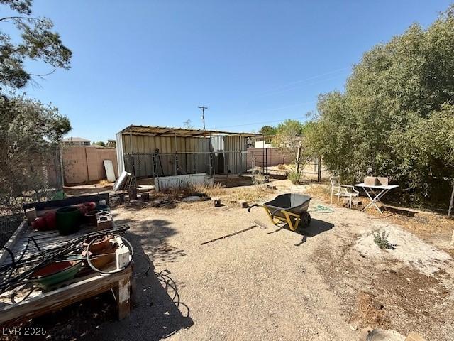 10561 Rancho Destino Rd, Las Vegas, NV 89183 - view of yard featuring an outdoor structure and fence