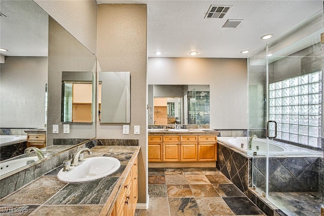 1742 Sand Storm Dr, Henderson, NV 89074 - bathroom featuring two vanities, visible vents, a garden tub, and a sink