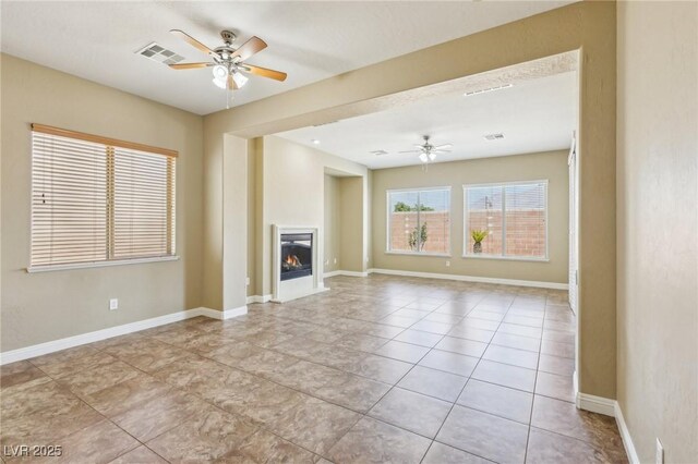 3904 Redbreast Ln, North Las Vegas, NV 89084 - unfurnished living room featuring tile patterned flooring, visible vents, a ceiling fan, and baseboards