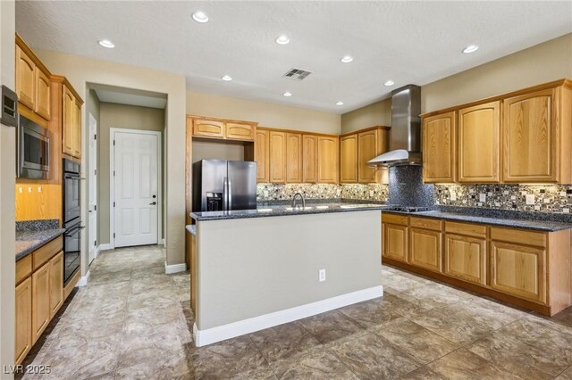 3904 Redbreast Ln, North Las Vegas, NV 89084 - kitchen featuring a kitchen island with sink, visible vents, backsplash, wall chimney range hood, and appliances with stainless steel finishes