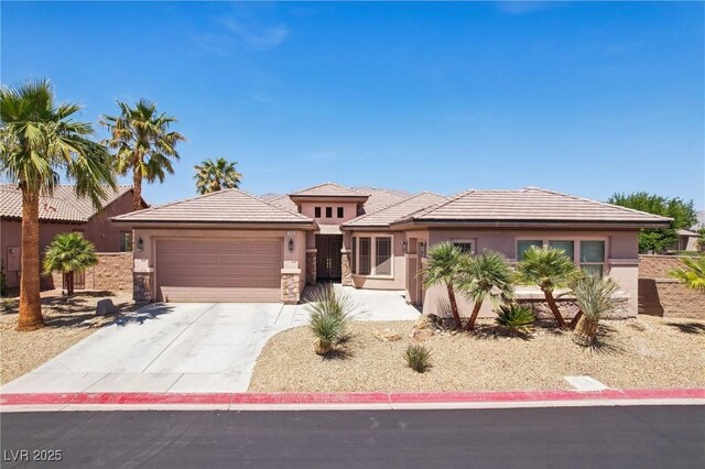 3904 Redbreast Ln, North Las Vegas, NV 89084 - prairie-style home with an attached garage, stone siding, concrete driveway, and stucco siding