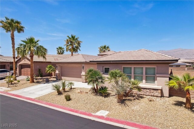 3904 Redbreast Ln, North Las Vegas, NV 89084 - single story home with an attached garage, driveway, stone siding, and stucco siding