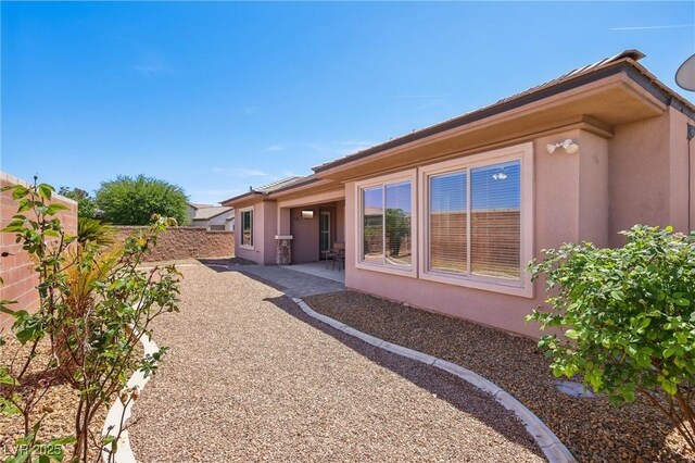 3904 Redbreast Ln, North Las Vegas, NV 89084 - back of house featuring a patio, stucco siding, and fence