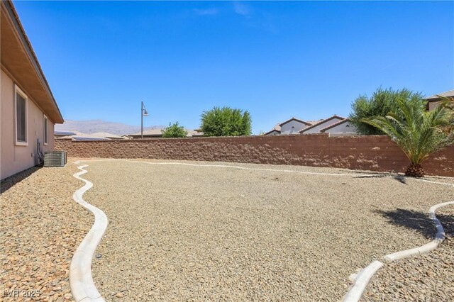 3904 Redbreast Ln, North Las Vegas, NV 89084 - view of yard with central air condition unit, fence private yard, and a mountain view