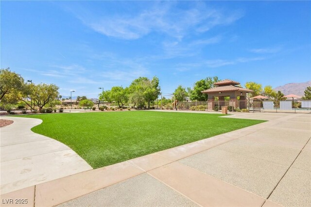 3904 Redbreast Ln, North Las Vegas, NV 89084 - surrounding community with fence, a lawn, a gazebo, and a mountain view