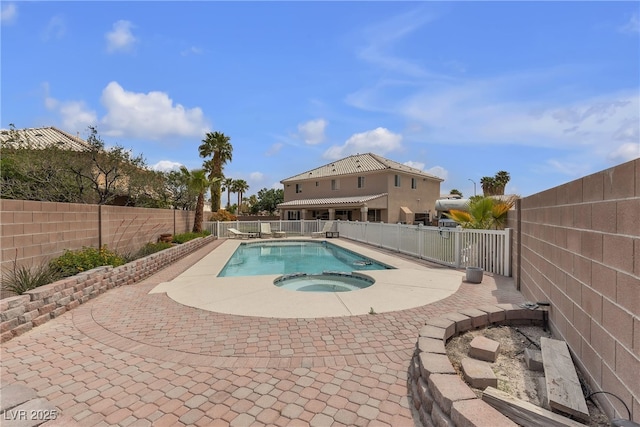 view of pool with a fenced backyard, a patio, a fenced in pool, and an in ground hot tub