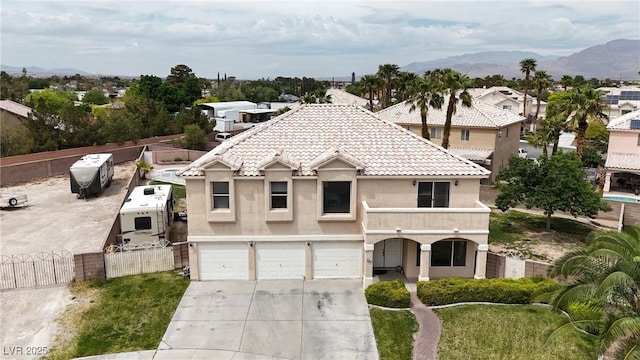 view of front of house with a gate, driveway, fence, a garage, and stucco siding