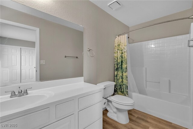 full bath featuring wood finished floors, vanity, shower / bath combination with curtain, toilet, and visible vents