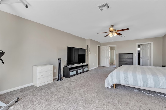 bedroom with carpet, visible vents, a ceiling fan, ensuite bath, and baseboards