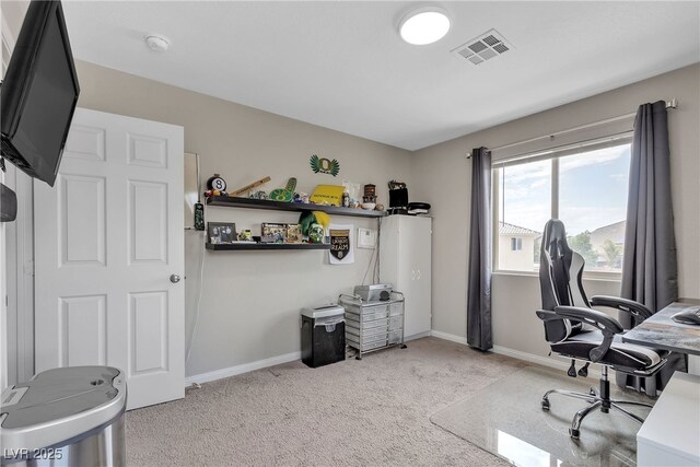 office area featuring baseboards, visible vents, and light colored carpet