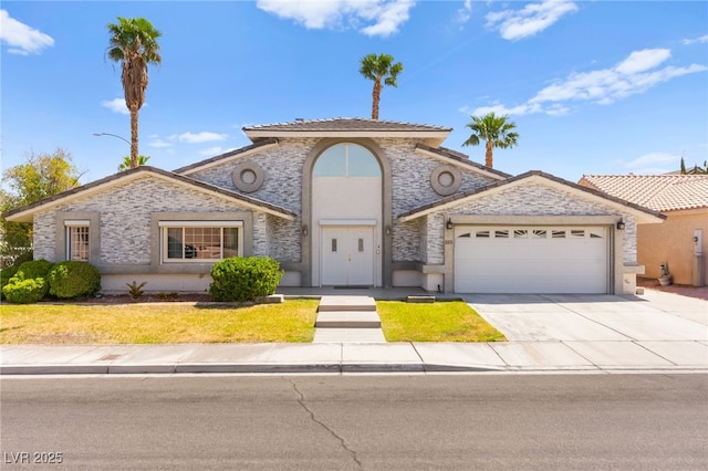 313 Firestone Dr, Las Vegas, NV 89145 - view of front of property featuring a front lawn, stucco siding, driveway, stone siding, and a garage