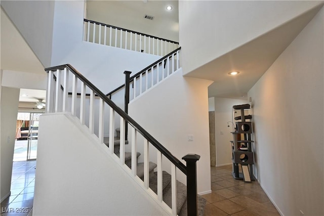 1105 Enderly Ln, Las Vegas, NV 89144 - staircase with ceiling fan, tile patterned floors, a high ceiling, and baseboards