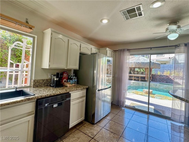 1105 Enderly Ln, Las Vegas, NV 89144 - kitchen featuring dishwasher, freestanding refrigerator, a sink, white cabinetry, and a ceiling fan