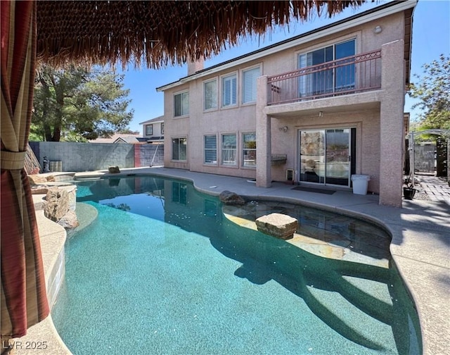 1105 Enderly Ln, Las Vegas, NV 89144 - back of house with a balcony, a fenced backyard, stucco siding, and a patio
