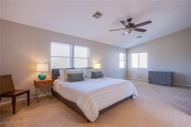 bedroom featuring baseboards, light colored carpet, lofted ceiling, and visible vents