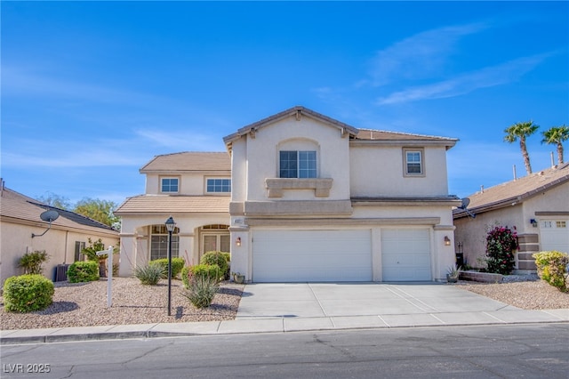view of front of property featuring a garage, stucco siding, driveway, and a tile roof