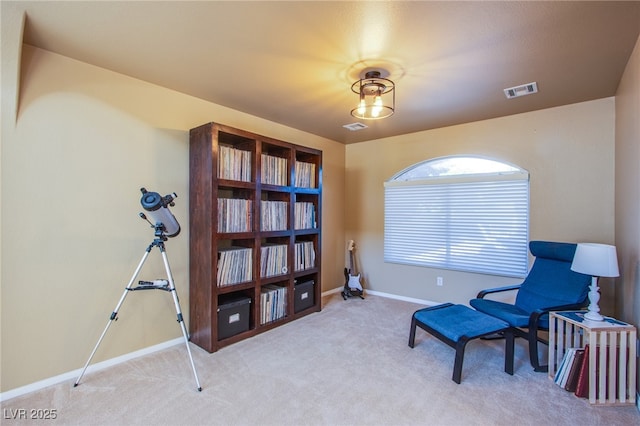 living area featuring carpet flooring, baseboards, and visible vents