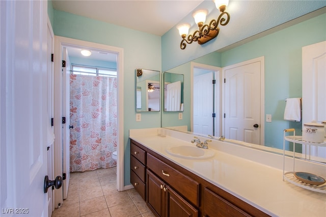 bathroom with vanity, tile patterned flooring, and toilet