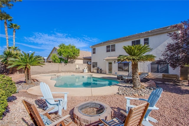 view of pool featuring a fenced in pool, a fenced backyard, a fire pit, and a patio