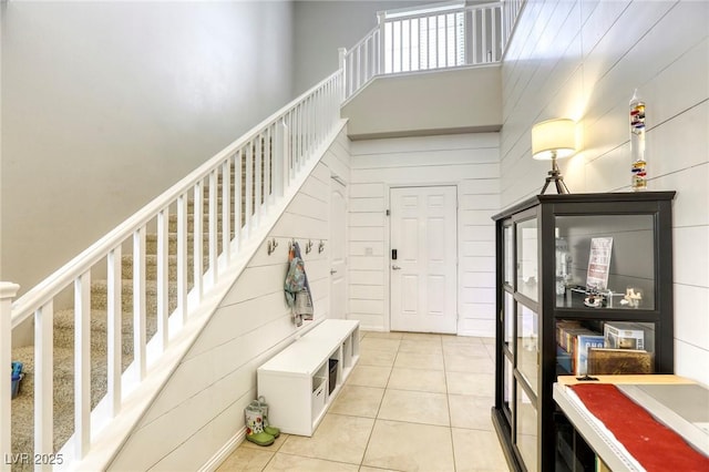 interior space with tile patterned floors and a towering ceiling