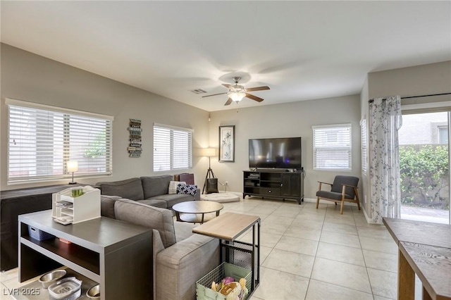 living area with ceiling fan, light tile patterned flooring, and visible vents
