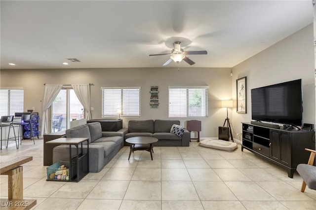 living area with a ceiling fan, recessed lighting, a healthy amount of sunlight, light tile patterned floors, and visible vents