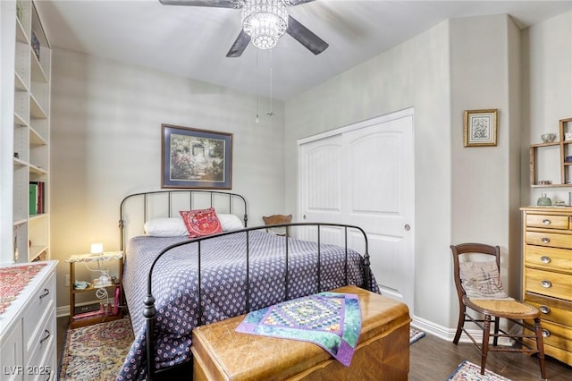 bedroom featuring a closet, dark wood-style flooring, ceiling fan, and baseboards