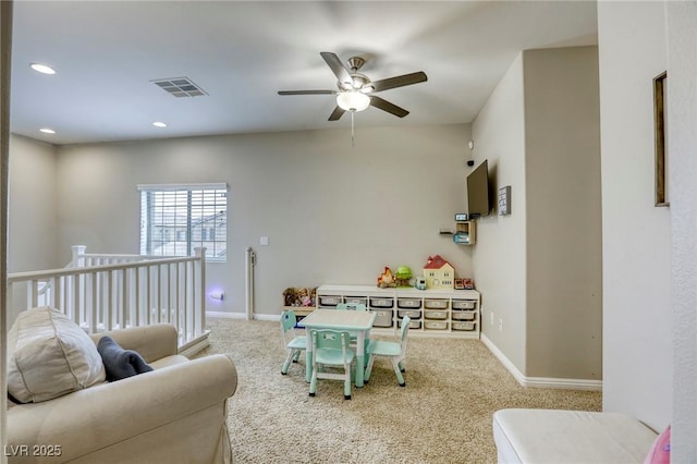 recreation room featuring carpet floors, baseboards, a ceiling fan, and visible vents