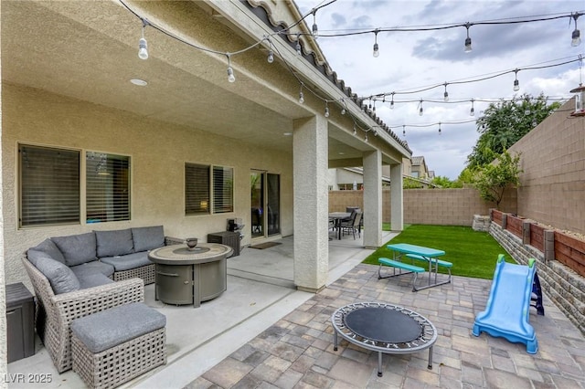 view of patio / terrace featuring a fenced backyard, outdoor dining space, and an outdoor living space with a fire pit