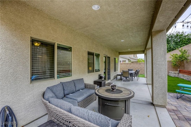 view of patio featuring a fenced backyard, outdoor dining space, and an outdoor living space