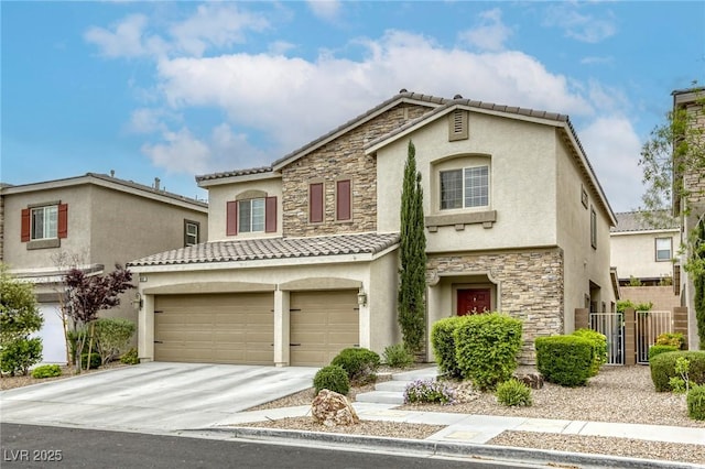 mediterranean / spanish house with fence, stone siding, stucco siding, an attached garage, and driveway
